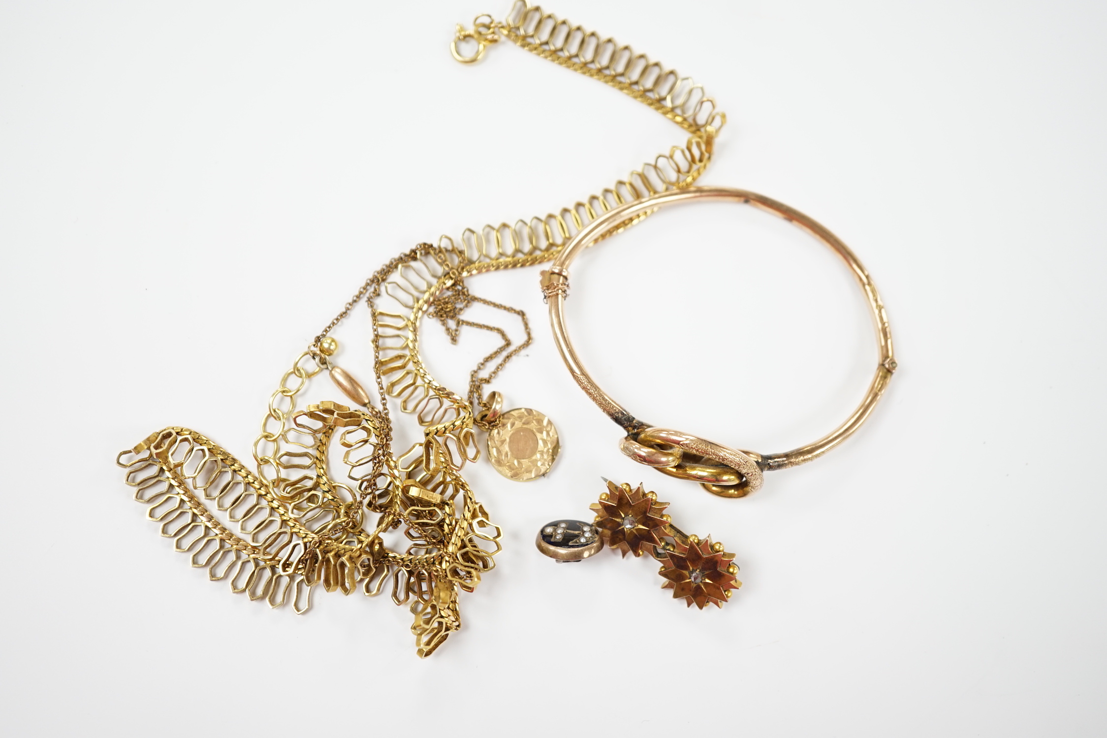 A 9ct. gold fringe necklace, 49cm(a.f.) a 9ct. gold bangle, 25.9 grams, a gold plated locket on a gold plated fine chain, a Victorian yellow metal and two stone diamond set brooch and a stick pin head.